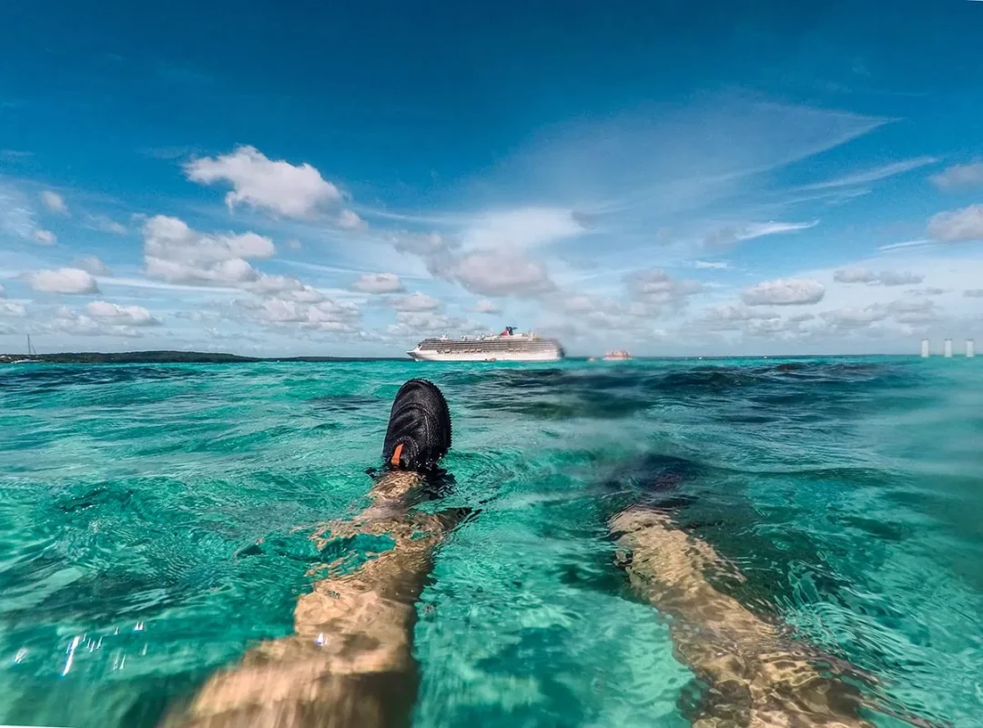 Tasha Amy floating in the water off Easo Beach with a view of a cruise ship in Lifou New Caledonia.