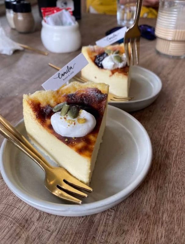 Best Restaurants In Pokhara: Cafes, Cheap Eats & Local Food 25 cheese cake on a plate with a golden fork from Camellia Cafe in Pokhara