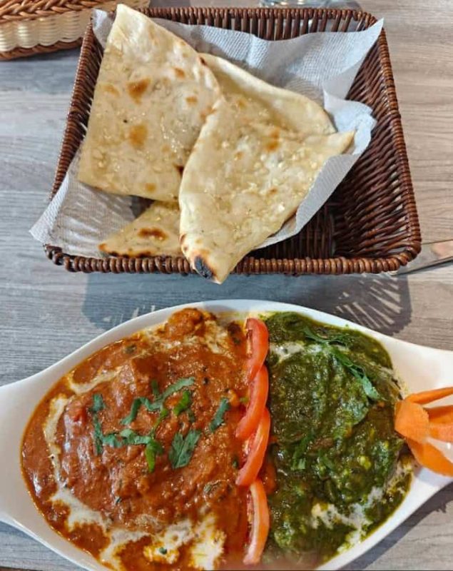Best Restaurants In Pokhara: Cafes, Cheap Eats & Local Food 33 two indian curries with naan bread from Utopia Garden & Snacks Restaurant in Pokhara
