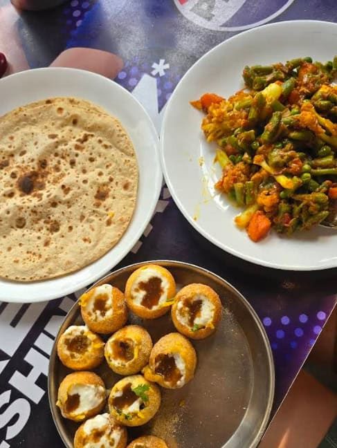 Best Restaurants In Pokhara: Cafes, Cheap Eats & Local Food 36 a plate of roti, vegetables, and pani puri from Spice Nepal Pure Vegetarian in Pokhara