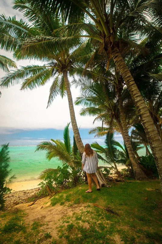 Scooter Hire In Rarotonga: Cost, Requirements, And Tips 22 Tasha Amy walking down a sandy path to the beach in Rarotonga