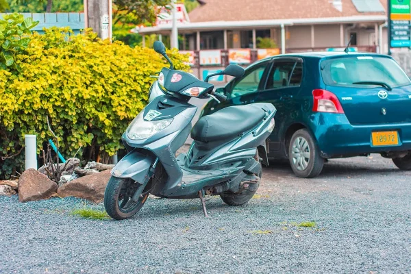my grey little ride when I hired a scooter in Rarotonga sitting in the carpark on a petrol station