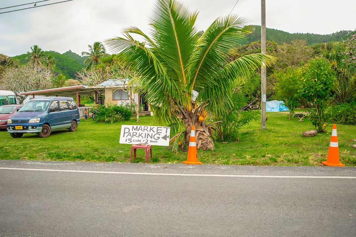 Scooter Hire In Rarotonga: Cost, Requirements, And Tips 17 A sign outside the Muri Night Market showing the parking location and fees for cars and scooters in Rarotonga