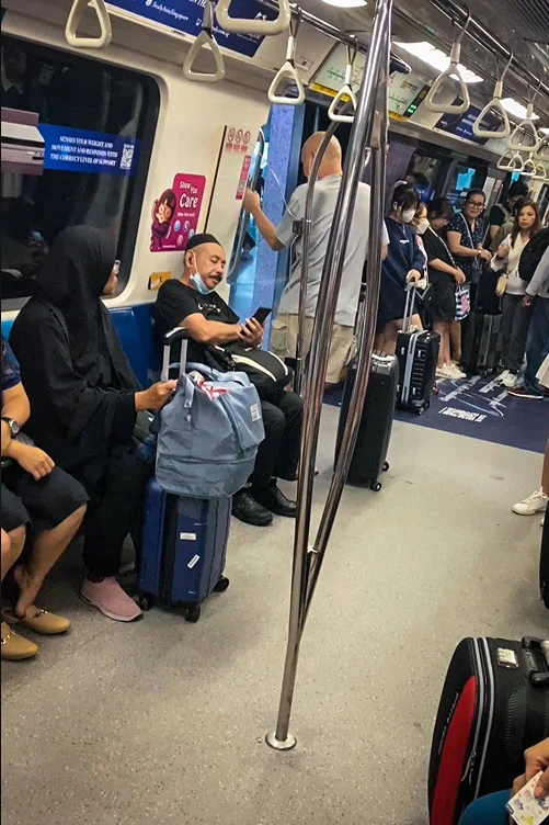 Tourists on the MRT from Singapore Airport with all their luggage