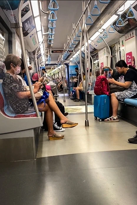 Catching the MRT from Changi Airport to the city with plenty of other travelers