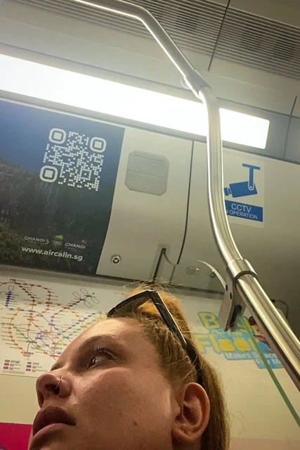 Tasha Amy sitting onboard the MRT traveling into the city