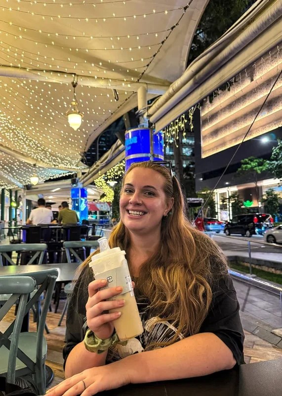 Spectra Light Show Singapore: Times, Best Views & Tips 24 Tasha Amy drinking a milk tea at Lau Pa Sat in Singapore at Night
