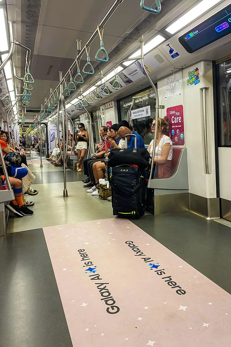 Taking the MRT in Singapore with passengers sitting down
