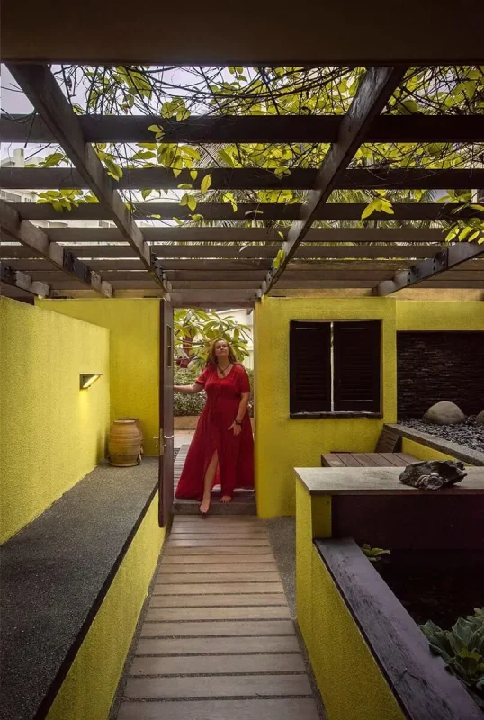Furama RiverFront Review: What It’s Really Like To Stay Here 18 Tasha walking into the private courtyard with a water feature and leafy pergola at Furama RiverFront