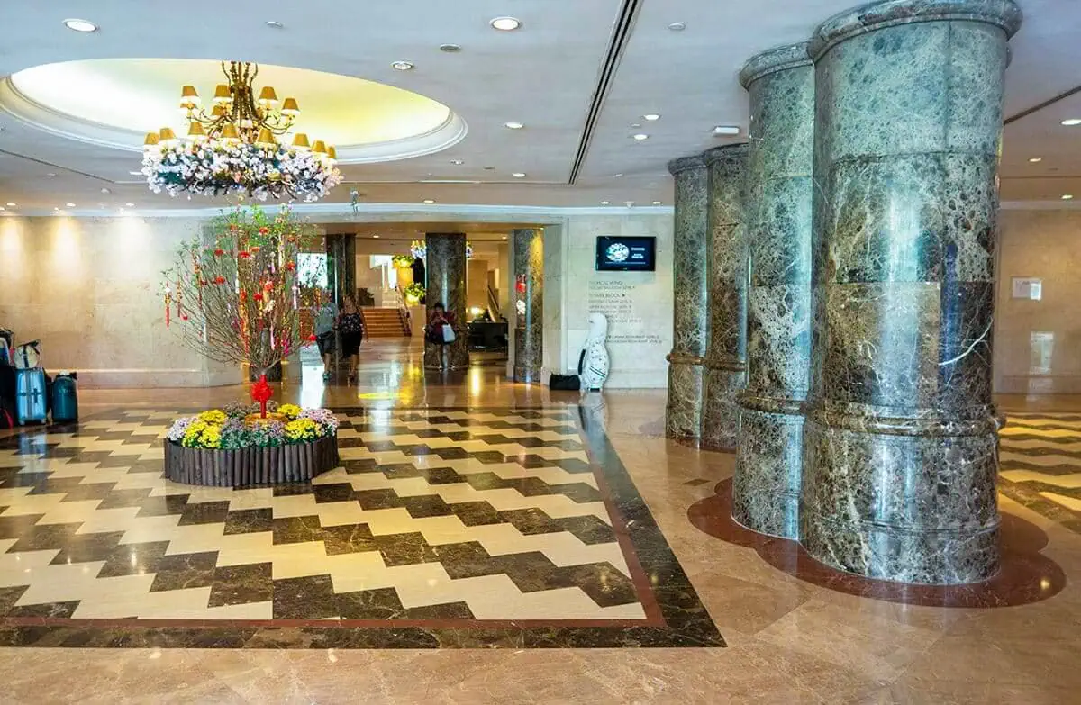 Furama RiverFront Review: What It’s Really Like To Stay Here 19 Furama RiverFront lobby with marble pillars, a chandelier and floral display