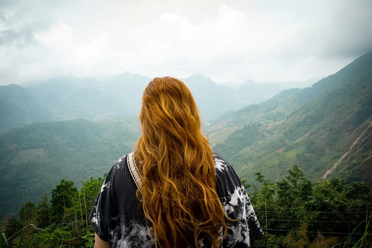 Tasha looking across a mountain valley in Ha Giang