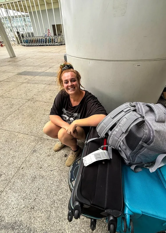 Hanoi Airport To Ha Giang: How To Get There 56 Tasha Amy waiting with luggage outside Hanoi Airport for the bus to Ha Giang