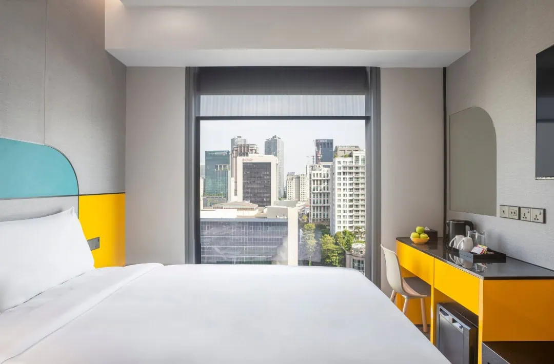 Hotel Mi Rochor Review: Is It Worth Staying Here? (2026) 32 Across the bed to the view out the window at Hotel Mi Rochor