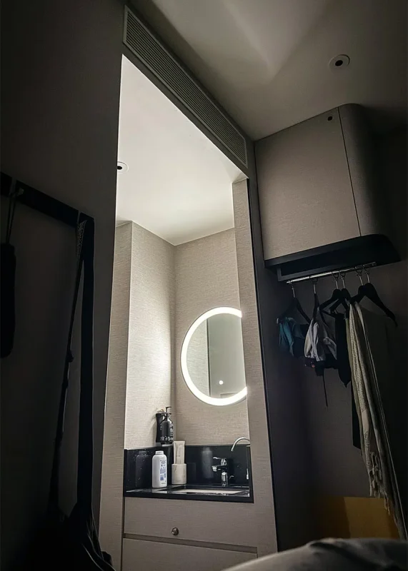 Hotel Mi Rochor Review: Is It Worth Staying Here? (2026) 21 Looking across to the sink in a dark room at Hotel Mi Rochor