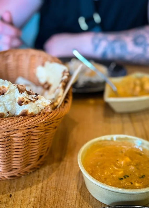 Hotel Mi Rochor Review: Is It Worth Staying Here? (2026) 27 A basket of Naan bread and butter chicken in Little India Singapore
