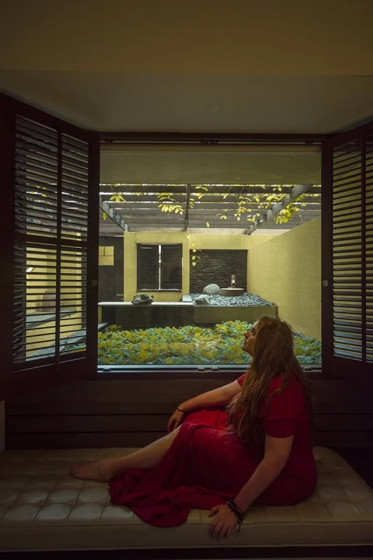 Where To Stay In Singapore: The 6 Best Areas & Hotels 43 Tasha Amy sitting on the bench seat in Furama Riverfront Singapore