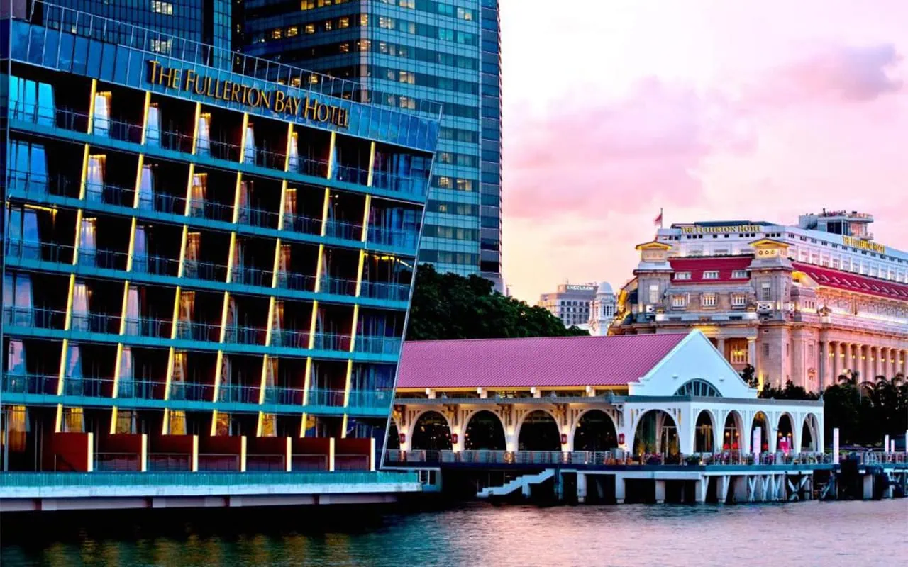 Where To Stay In Singapore: The 6 Best Areas & Hotels 40 Exterior of The Fullerton Bay Hotel beside the Marina Bay waterfront at sunset