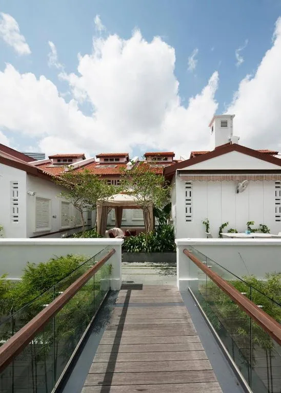 Where To Stay In Singapore: The 6 Best Areas & Hotels 33 Outdoor walkway connecting the white heritage buildings at The Sultan hotel in Singapore.