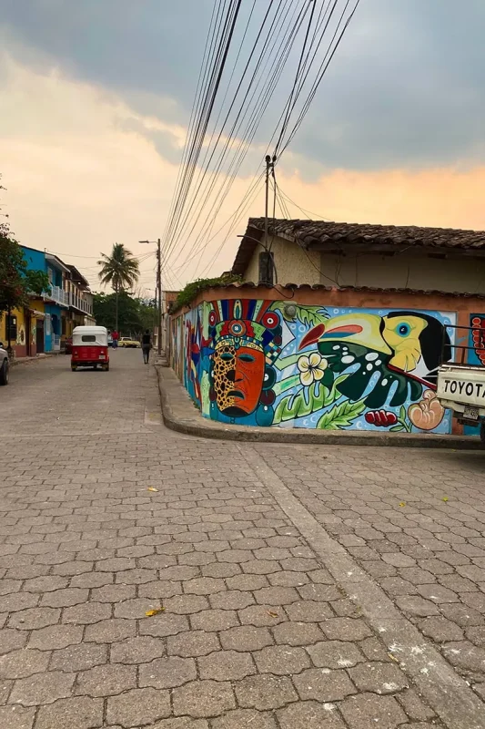2 Weeks In Honduras Itinerary: My Recommended Route 22 Colorful toucan mural beside a cobblestone street in Copan Ruinas