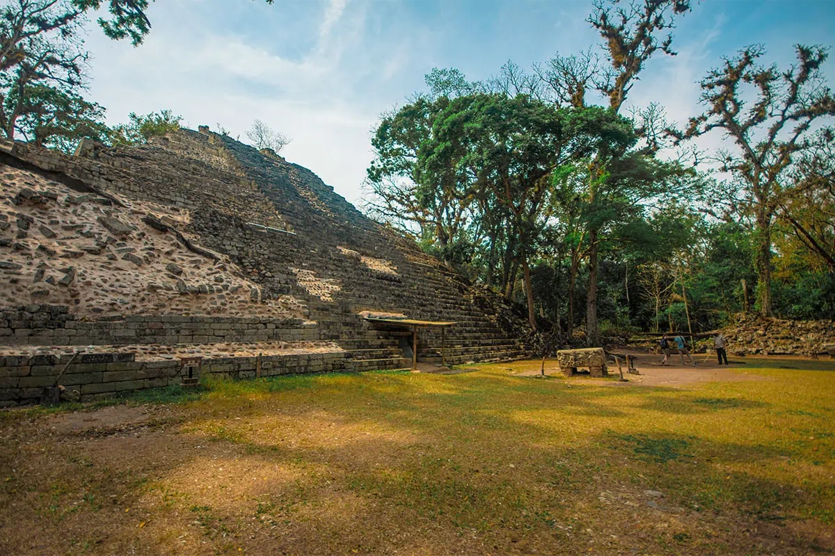 2 Weeks In Honduras Itinerary: My Recommended Route 25 Large stepped stone structure beside a grassy courtyard at the Copan Ruin