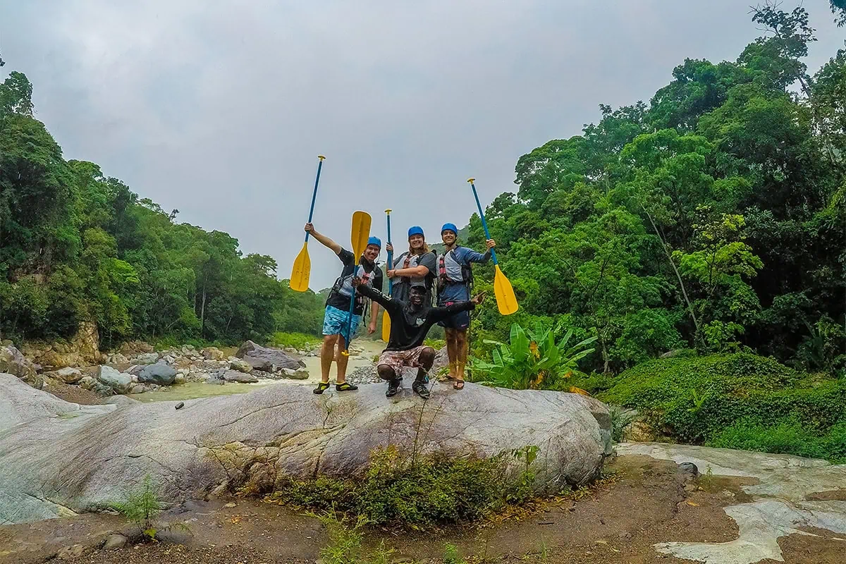 White Water Rafting In La Ceiba: My Experience On The Cangrejal River 28 Group of white water rafters holding paddles on the banks of the Cangrejal River in Pico Bonito National Park