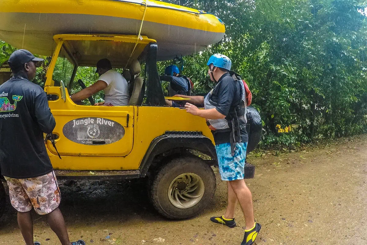 White Water Rafting In La Ceiba: My Experience On The Cangrejal River 34 Travelers loading rafting equipment into a yellow Jungle River Lodge Jeep