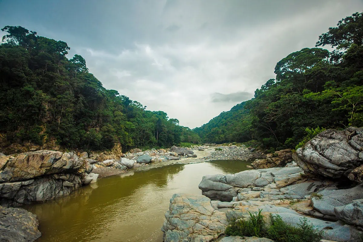 White Water Rafting In La Ceiba: My Experience On The Cangrejal River 44 Natural swimming pool surrounded by boulders and rainforest beside the Cangrejal River in Pico Bonito National Park