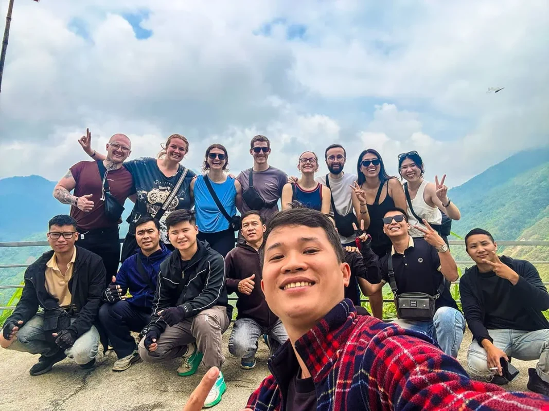 Road Kings Ha Giang tour group and Easy Riders taking a selfie at a mountain viewpoint
