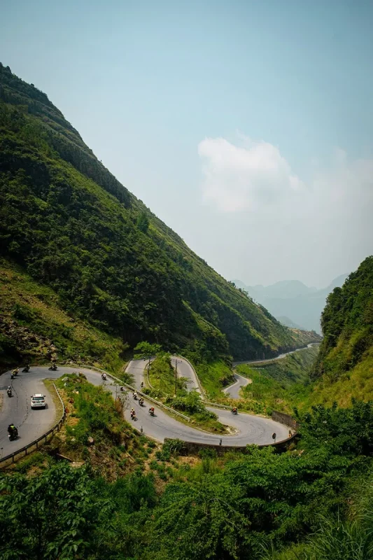 Motorbikes following winding hairpin roads through the mountains of Ha Giang