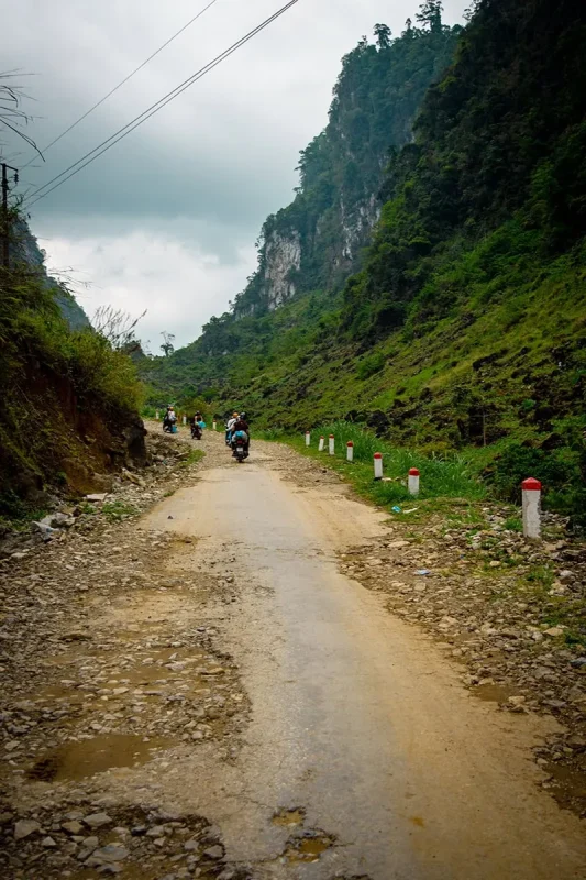 Easy Riders traveling along a rough mountain road on the Ha Giang Loop