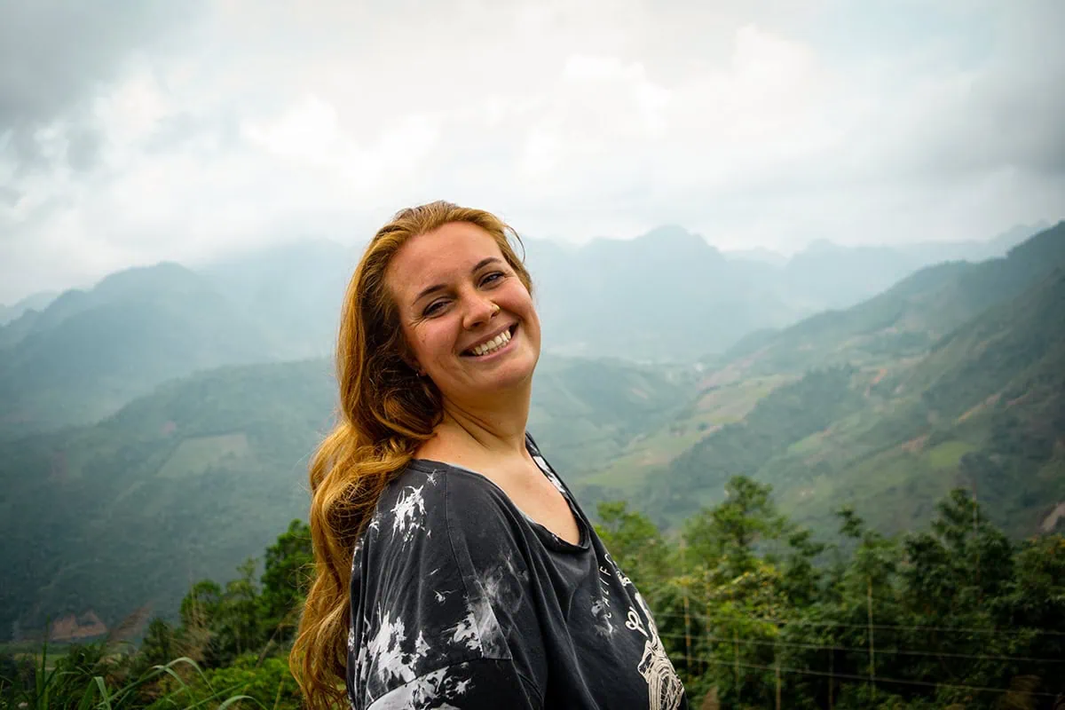 Tasha smiling at a mountain viewpoint along the Ha Giang Loop