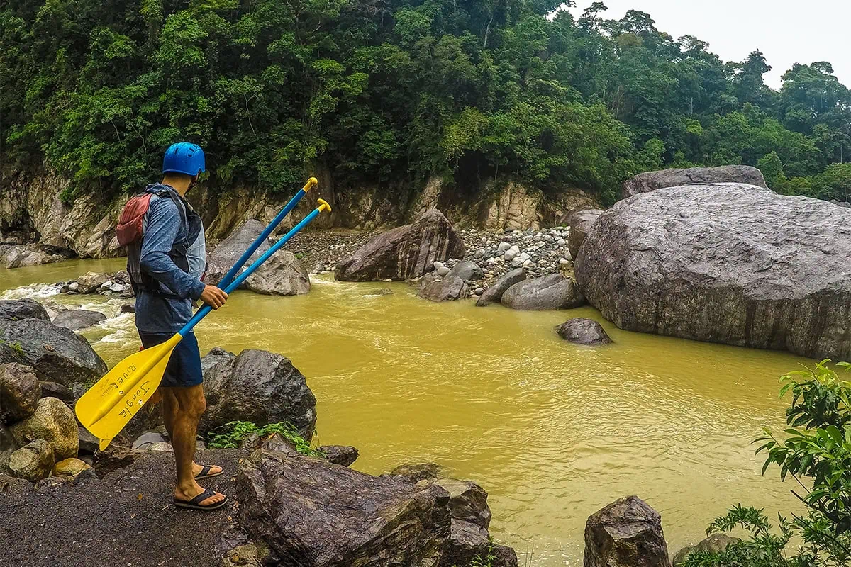 White Water Rafting In La Ceiba: My Experience On The Cangrejal River 37 Rafter holding paddles in Pico Bonito National Park