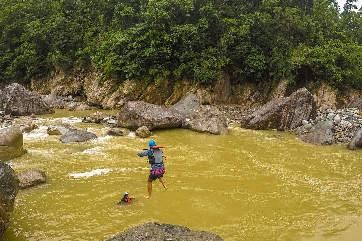 White Water Rafting In La Ceiba: My Experience On The Cangrejal River 31 Traveler jumping from a boulder into the Cangrejal River during a canyoning tour