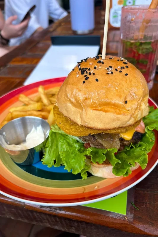 Best Hostels In Ha Giang: Where To Stay Before The Loop 57 Burger with lettuce and cheese served with fries and dipping sauce at Top Of The Loop Hostel in Ha Giang