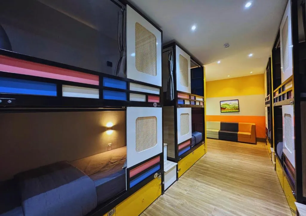 Best Hostels In Ha Giang: Where To Stay Before The Loop 62 Enclosed bunk beds with individual lights and yellow storage drawers in Ha Giang Hostel