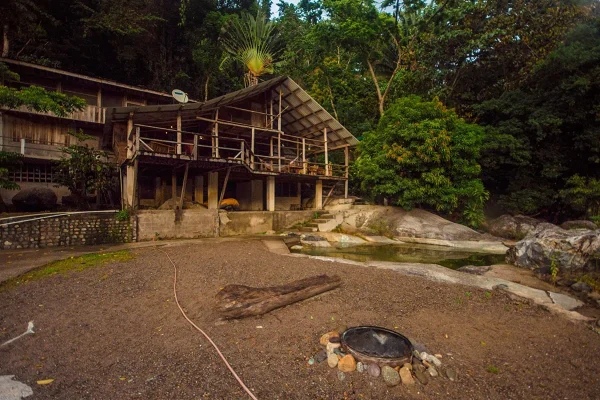 Wooden terrace and natural rock pool at Jungle River Lodge, one of the best hostels in La Ceiba
