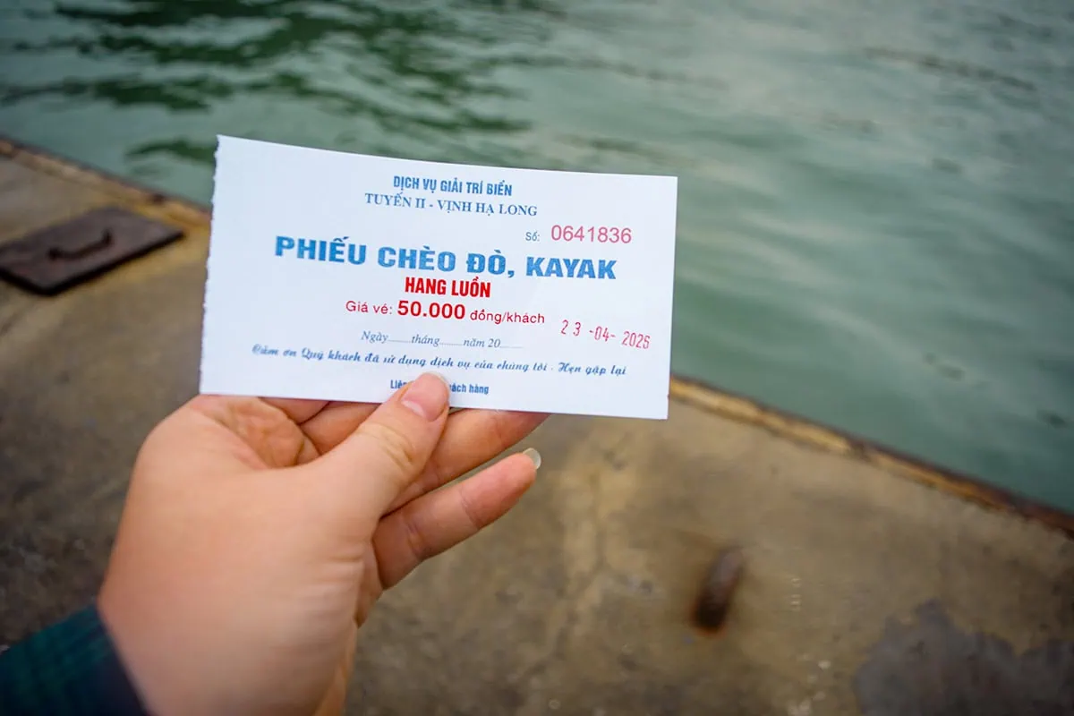 Luon Cave Ha Long Bay: Is It Worth Visiting? 67 Hand holding a Luon Cave boat and kayak ticket marked 50,000 VND per person