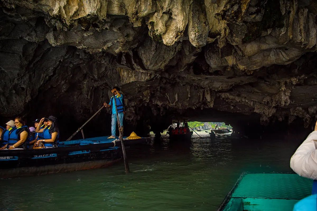 Luon Cave Ha Long Bay: Is It Worth Visiting? 69 A rower guiding passengers through Luon Cave beneath the limestone ceiling