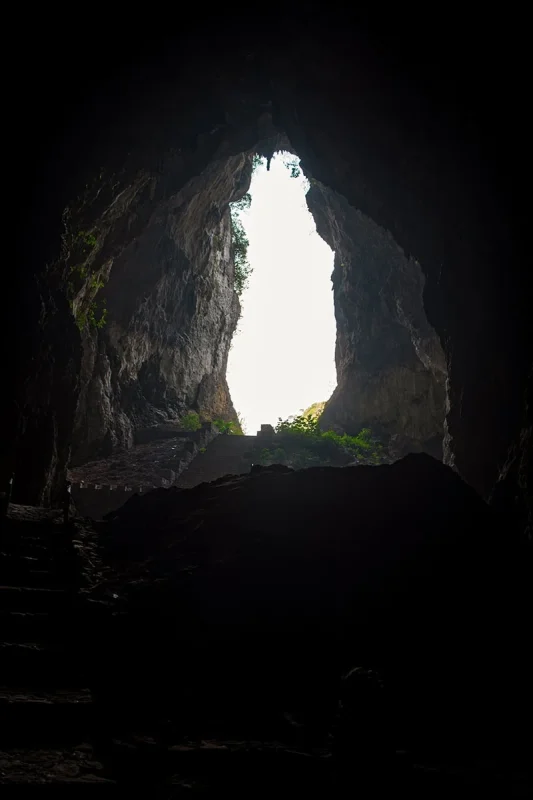 Daylight shining through the tall entrance of Ta Lung Cave when viewed from inside