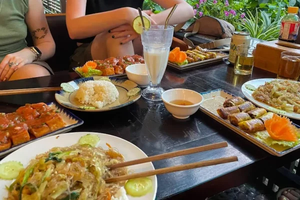 Tofu, vegetable noodles, spring rolls and rice on a table at Nha Hang Chay Ha Giang, the perfect spot if you're wondering where to eat in Ha Giang